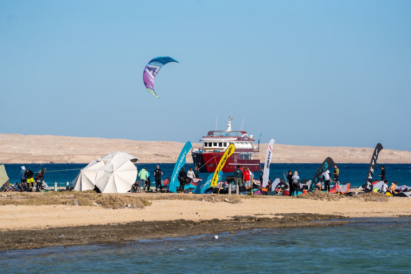 Safari boat anchored off the beach with kites set up