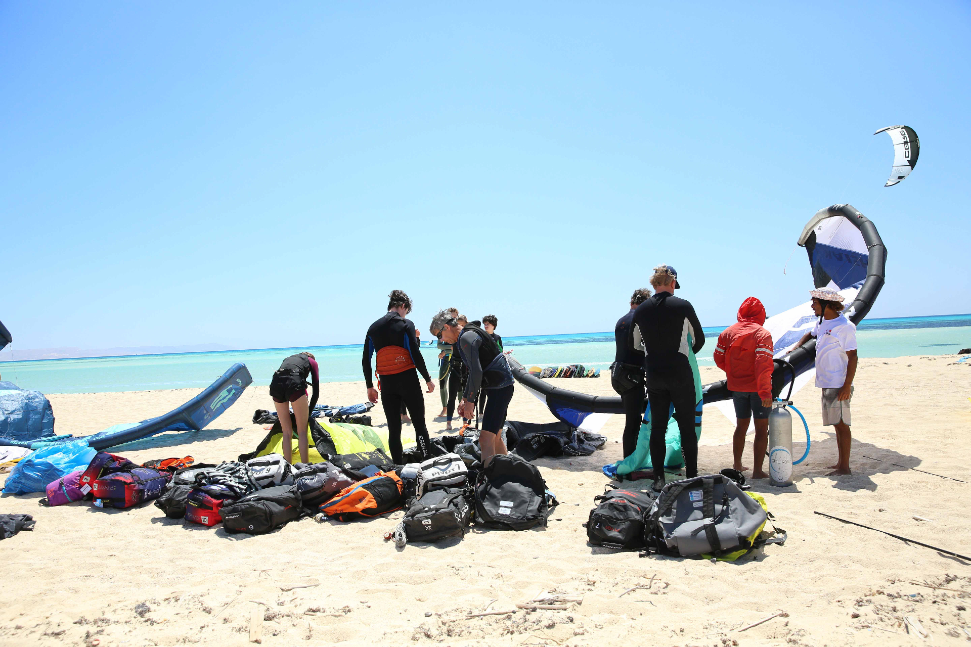 Guests setting up kites on a sandy safari island