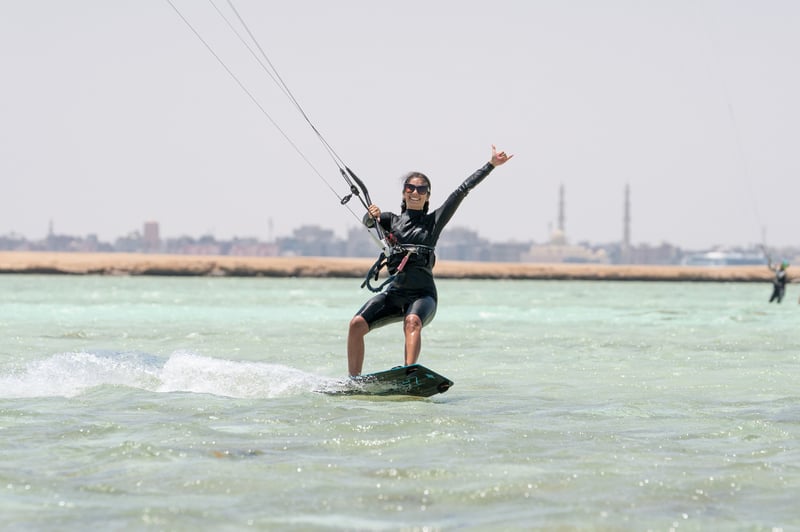 Smiling rider throwing a shaka on flat Red Sea water