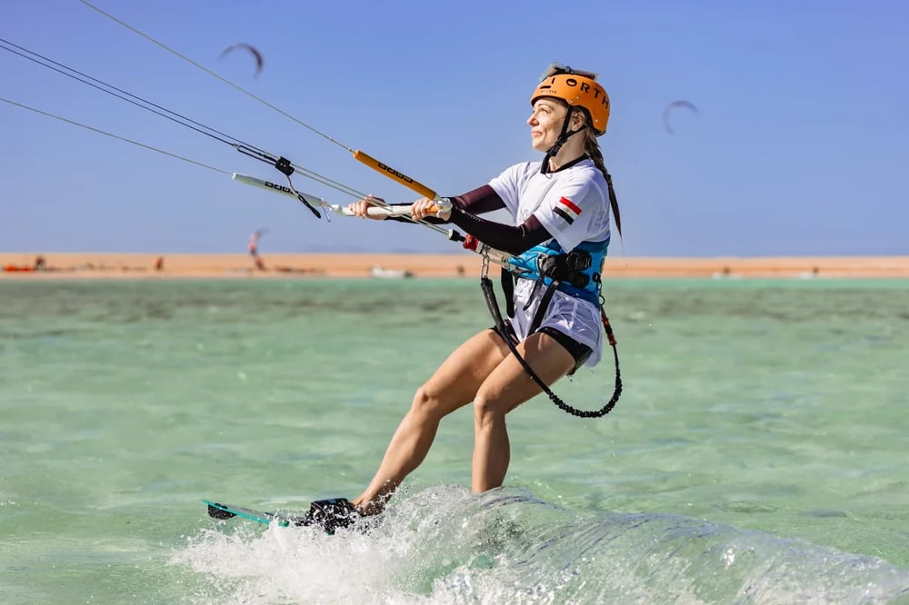 Camper kitesurfing across the shallow turquoise lagoon in El Gouna