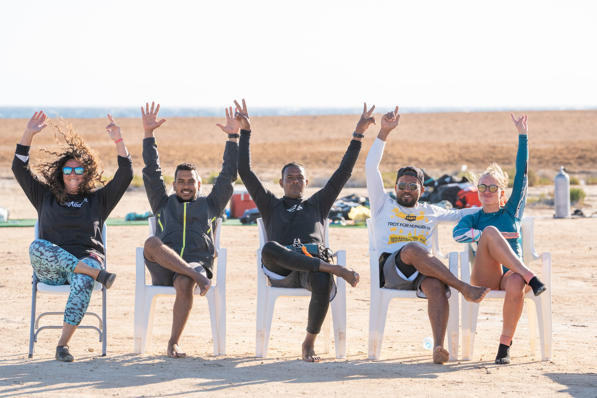 Happy kite crew cheering on the beach after a session