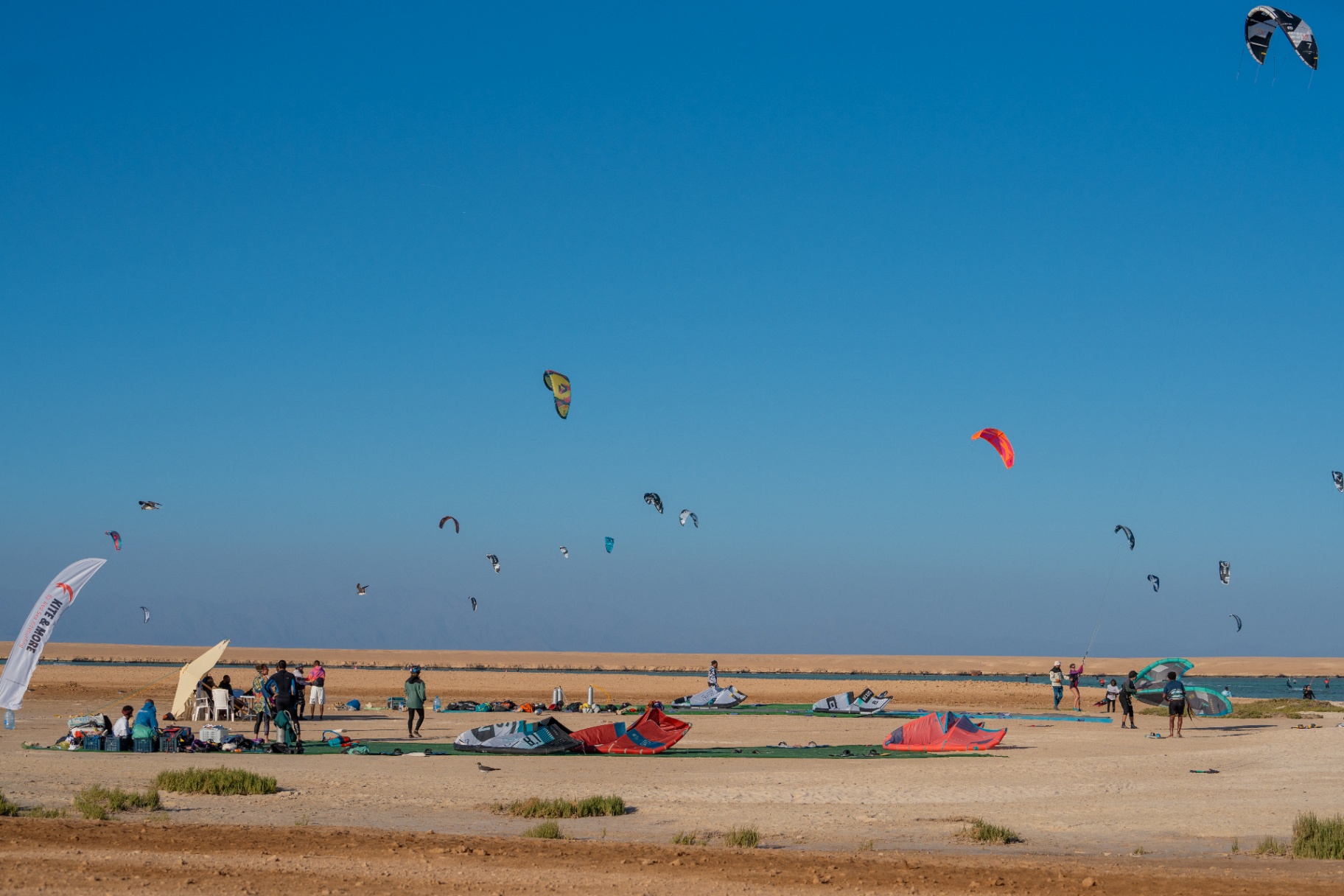 Wide view of the kite safari spot with riders across the lagoon