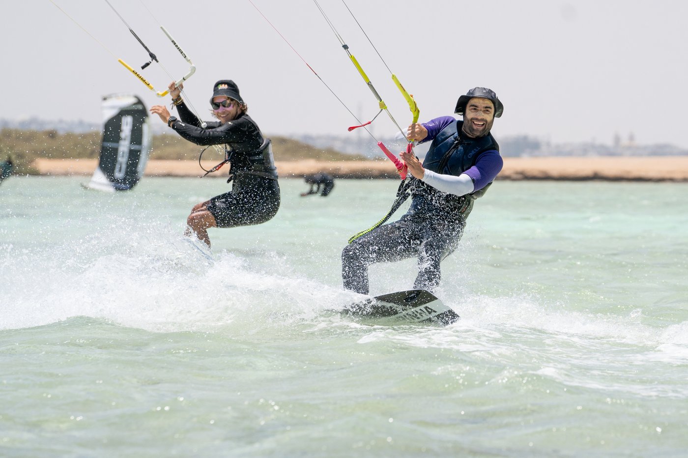 Two riders carving through clear Red Sea water