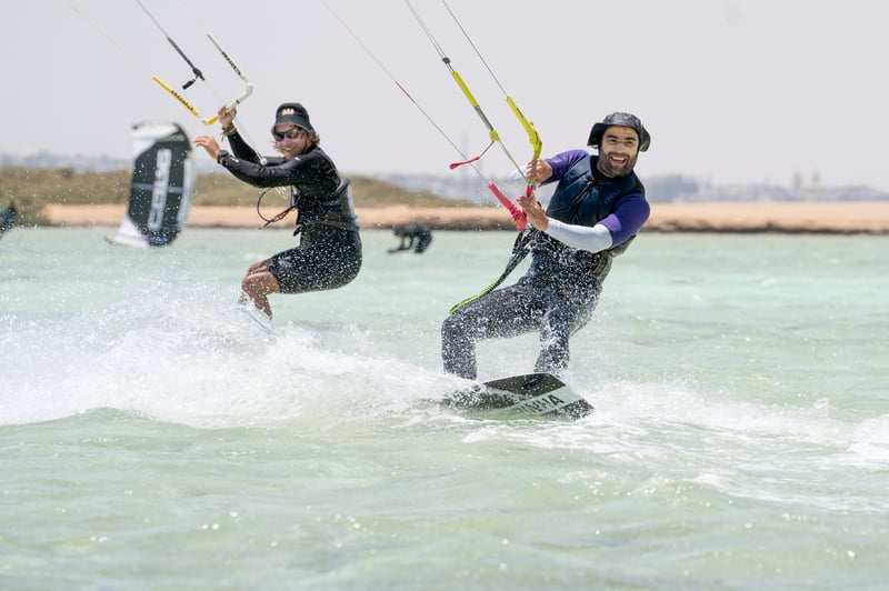 Two riders carving through clear Red Sea water
