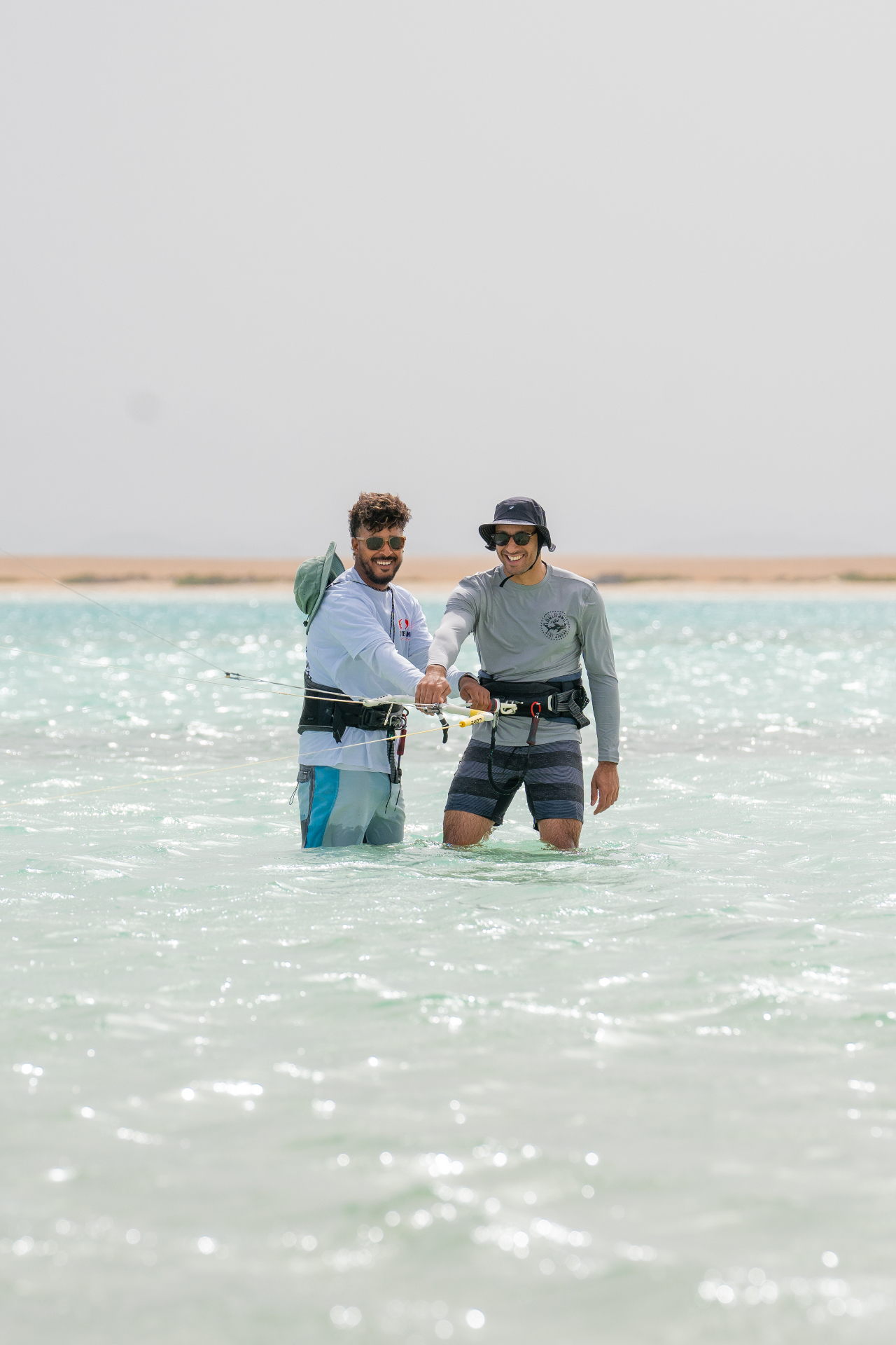 Kite instructor coaching a student in a Red Sea lagoon