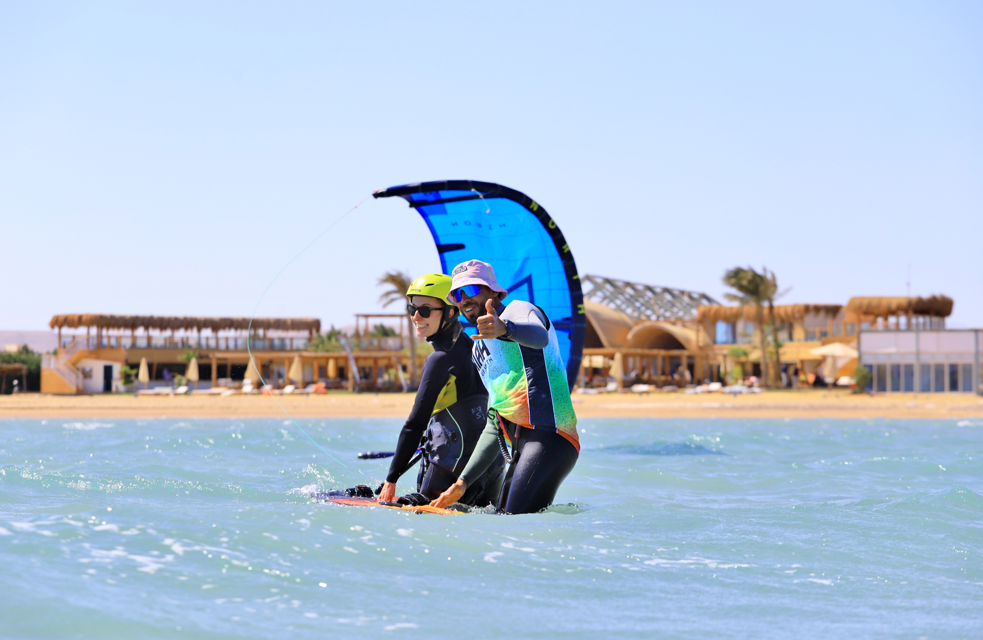 Instructor coaching a student in shallow El Gouna water