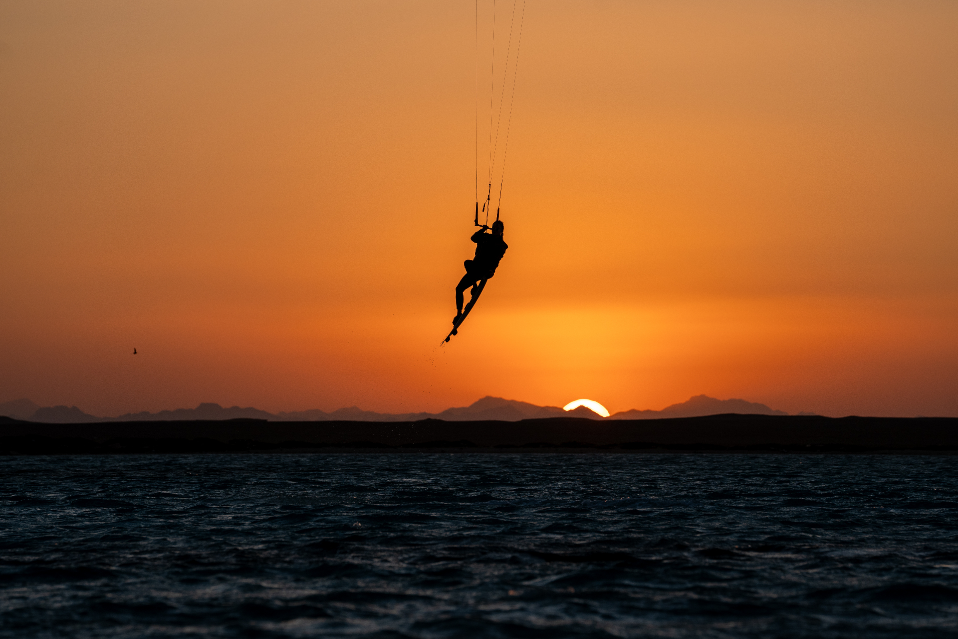 Kitesurfer silhouetted during sunset