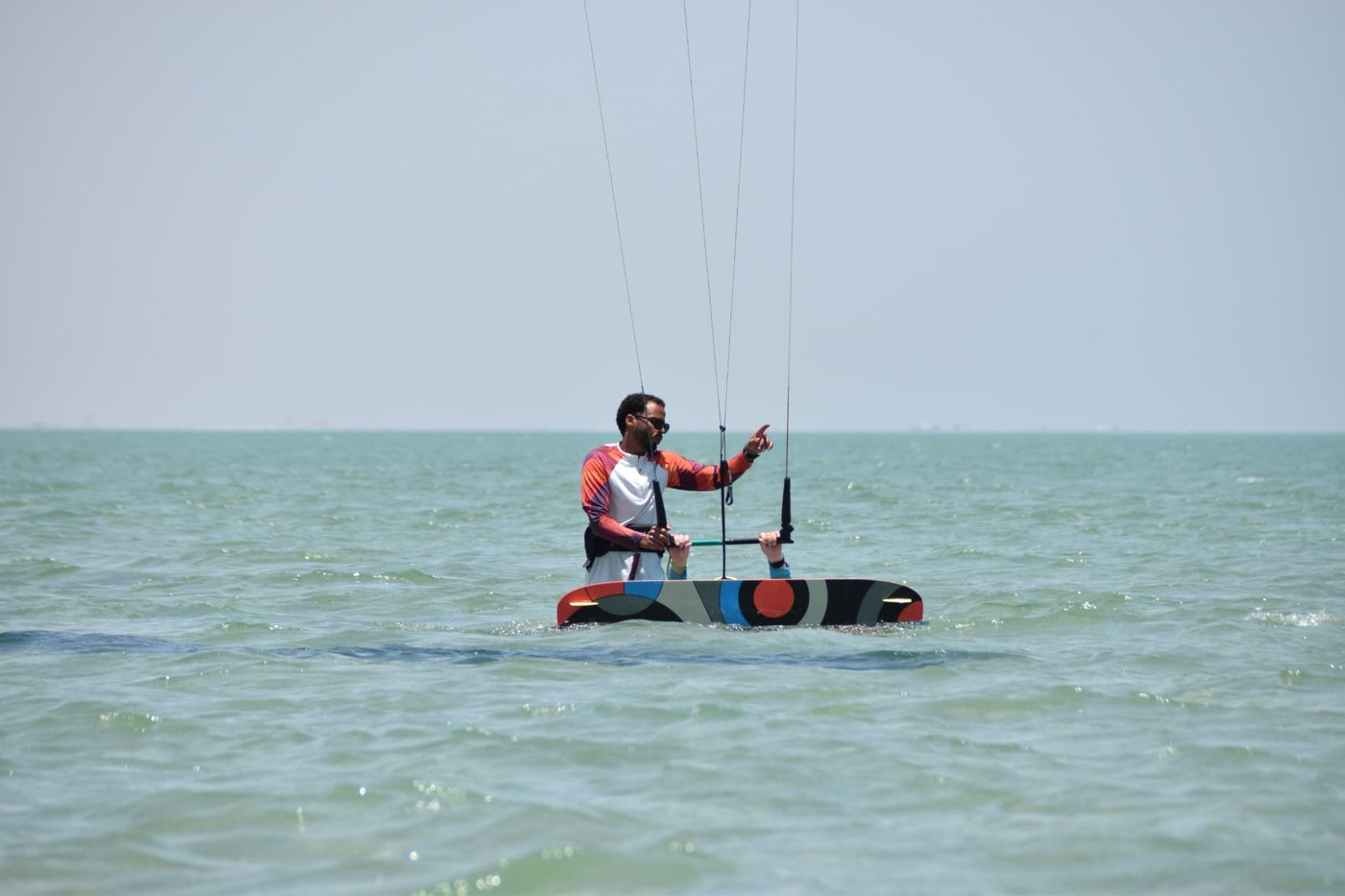 Instructor guiding a student on bar control in waist-deep water