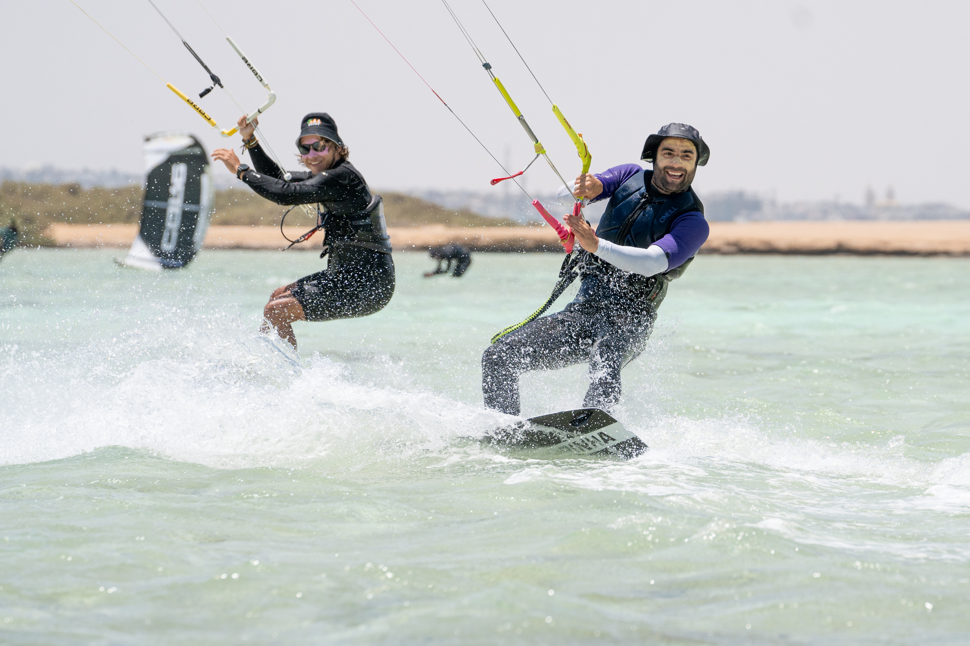 Two riders carving through clear Red Sea water