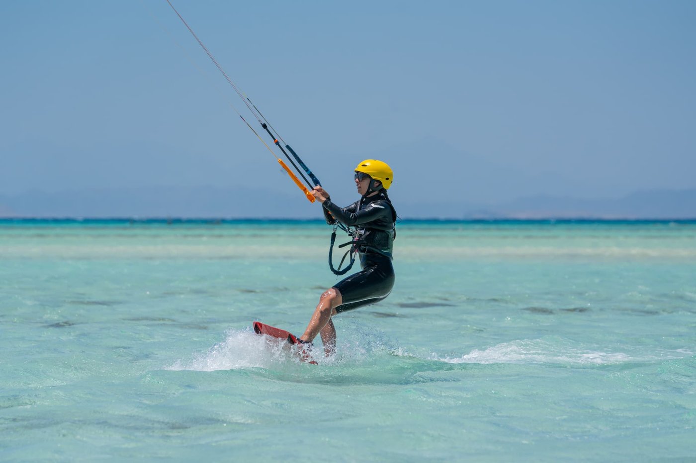 Student carving through the flat El Gouna lagoon during a lesson