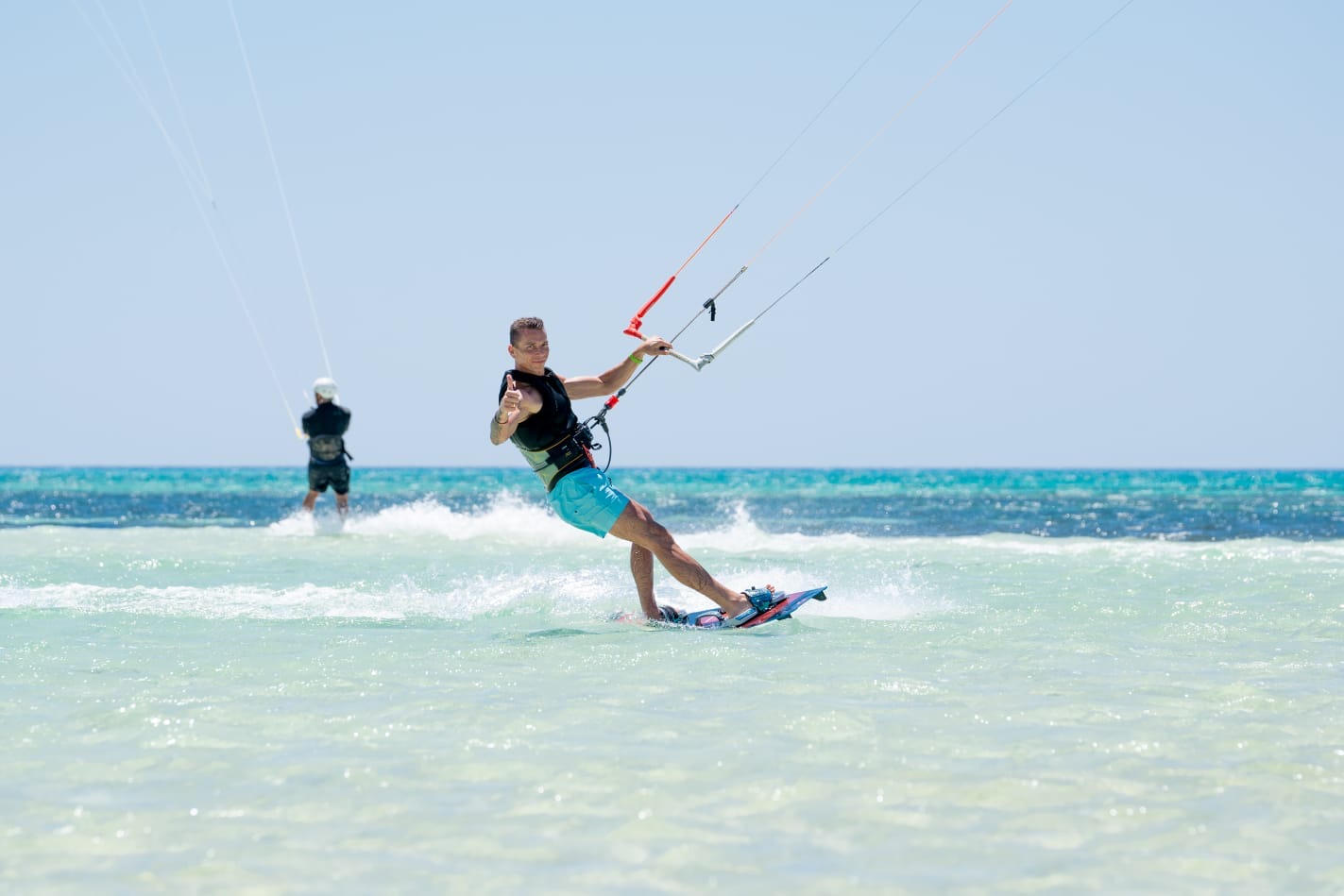 Rider giving a thumbs-up while cruising on flat water