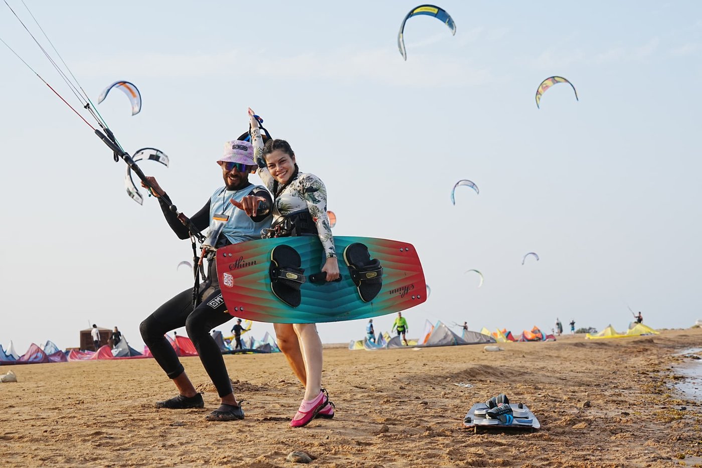 Instructor and student on the beach with kites and a board in El Gouna