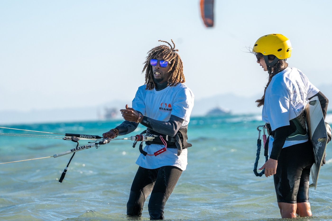 Instructor showing a first-timer kite control in shallow El Gouna water