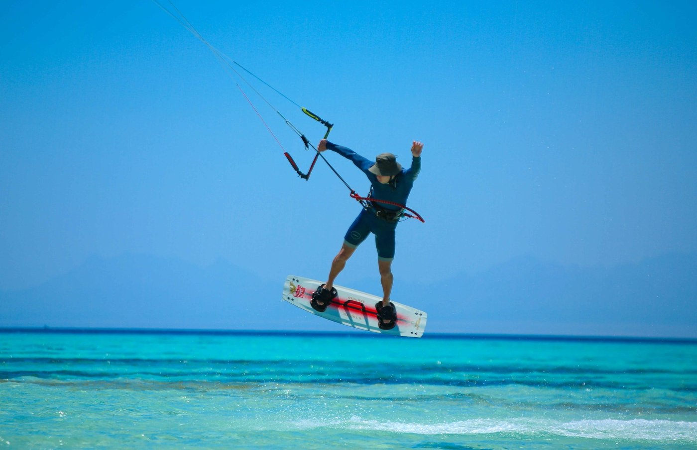 Kitesurfer boosting a first jump over the flat El Gouna lagoon