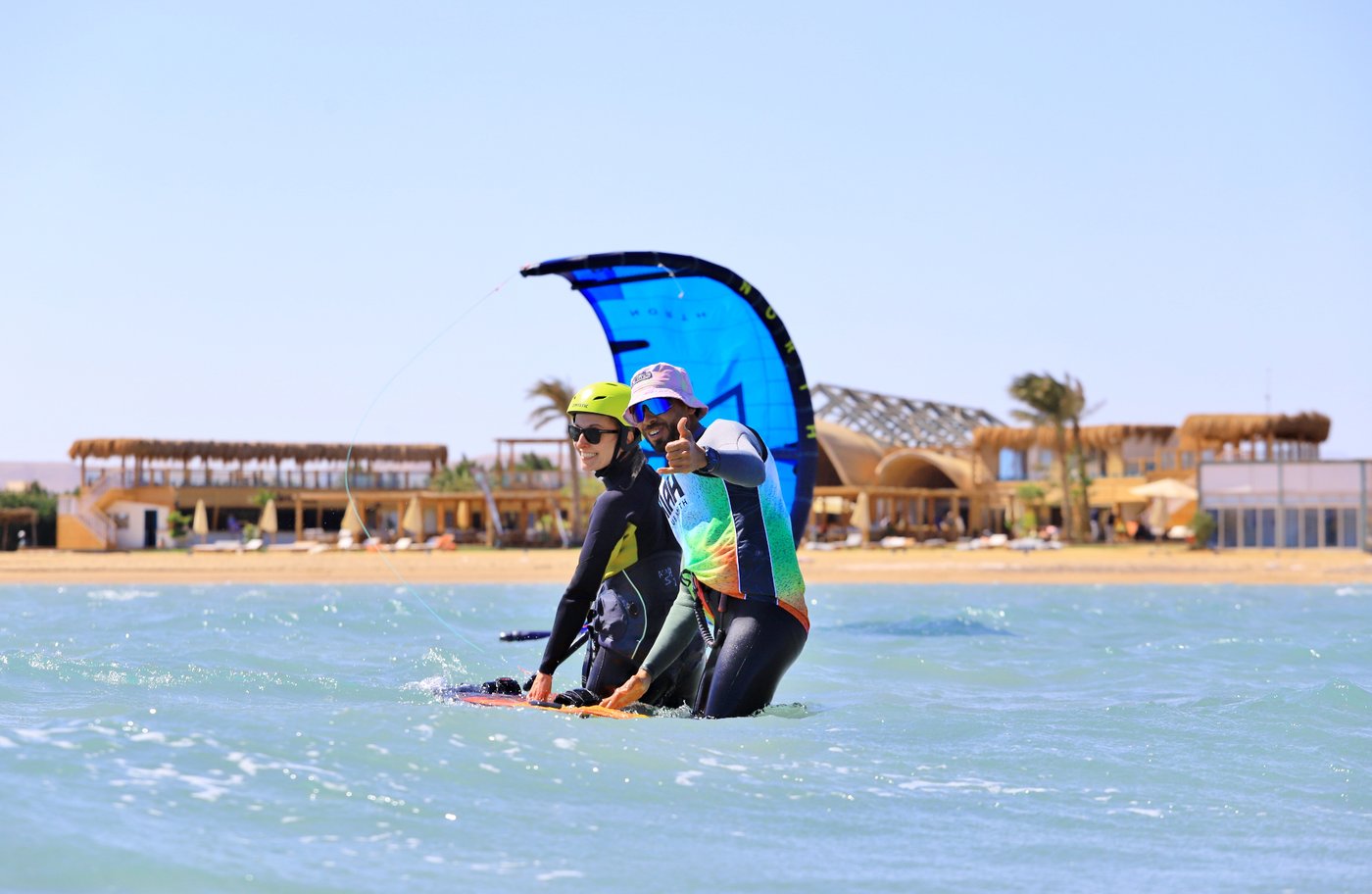 Instructor coaching a student in shallow El Gouna water